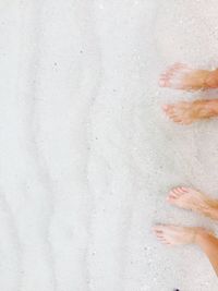 Low section of woman on sand