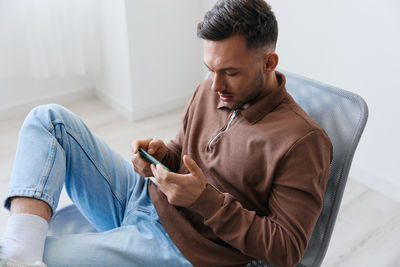 Side view of man using mobile phone