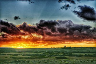 Scenic view of landscape against cloudy sky