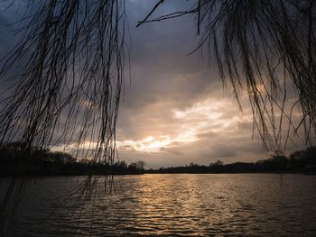 Scenic view of lake against sky at sunset