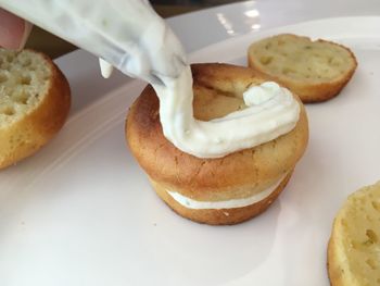 Close-up of hand in plate on table