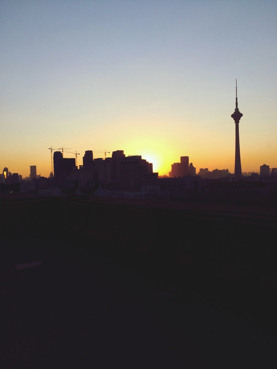 architecture, sunset, building exterior, built structure, silhouette, copy space, tower, city, clear sky, orange color, communications tower, tall - high, spire, sky, travel destinations, cityscape, dusk, capital cities, skyscraper, outdoors