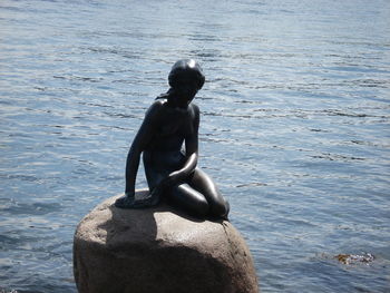 Man sitting on statue