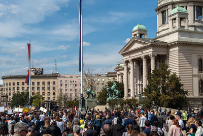 Group of people in front of buildings in city