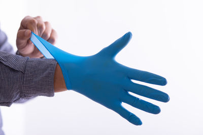 Close-up of hands over white background