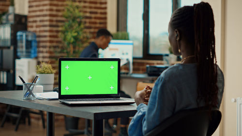 Woman using laptop at table