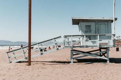 Lifeguard hut on beach against sky