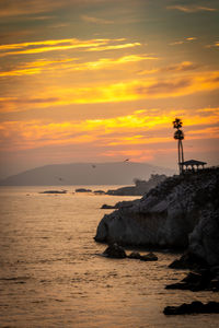 Scenic view of sea against orange sky