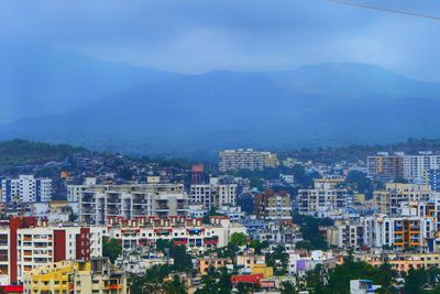 High angle view of buildings in city against sky