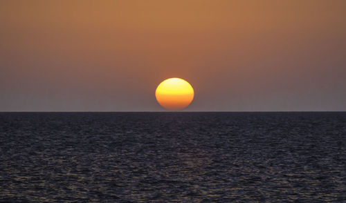 Scenic view of sea against clear sky during sunset