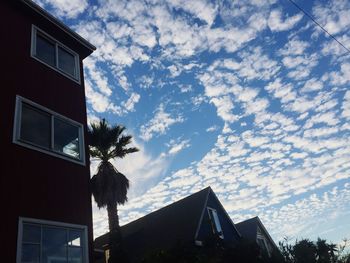 Low angle view of building against cloudy sky