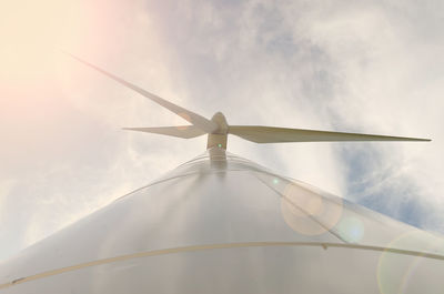 Low angle view of windmill against cloudy sky