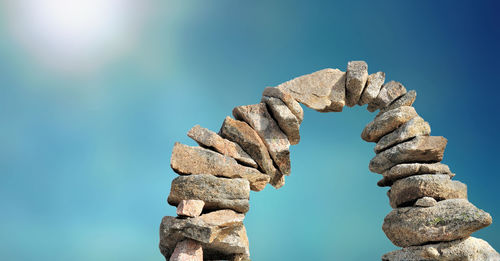 Low angle view of rocks against blue sky