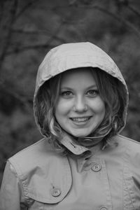 Close-up portrait of smiling young woman wearing hood