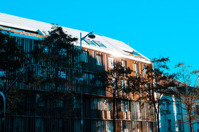 Low angle view of building against clear blue sky