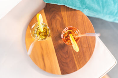 High angle view of hand holding glass on table