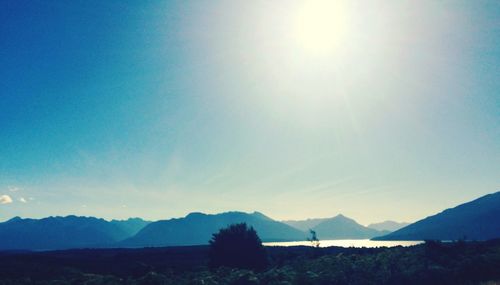 Scenic view of silhouette mountains against clear blue sky