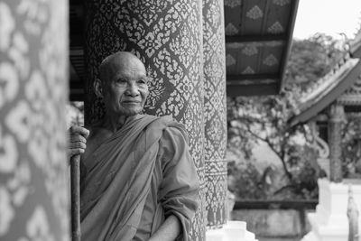 Portrait of buddha statue against building