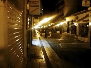 Illuminated city street at night