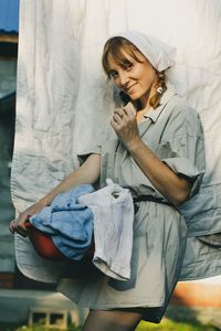 Mid adult woman sitting on bed at home