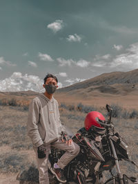 Man standing on land against sky