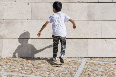 Young boy jumping while having fun in a park.