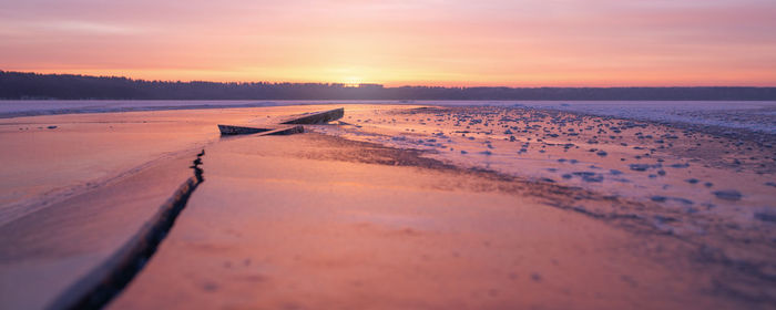 Scenic view of beach against sky during sunset