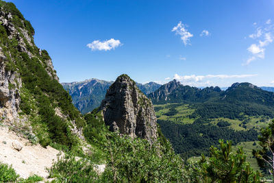 Scenic view of mountains against blue sky