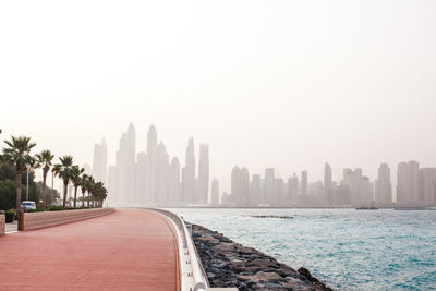 Panoramic view of sea and buildings against clear sky