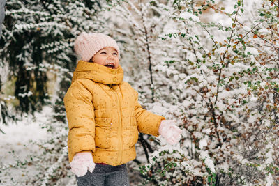 Portrait of cute girl standing in snow