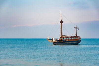 Sailboat sailing on sea against sky