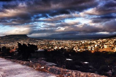 Cityscape against cloudy sky