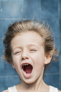 Close-up of cute boy with mouth open