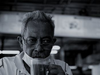 Portrait of man drinking glasses outdoors