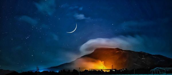 Scenic view of mountain against sky at night