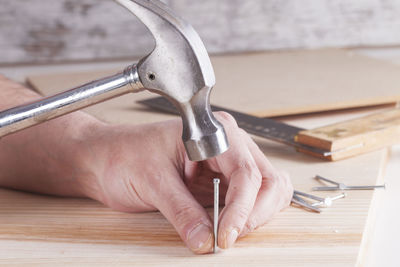 Close-up of hands working on table