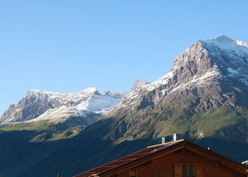 Scenic view of mountains against clear blue sky