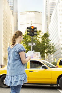 Woman on street reading map