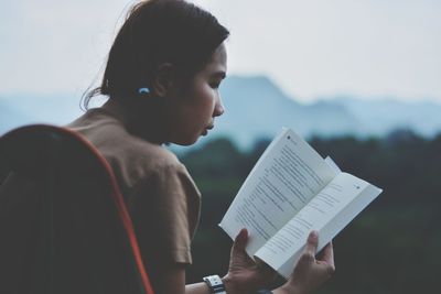 Young woman reading book