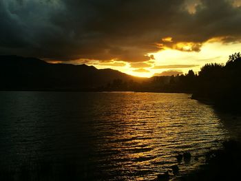 Scenic view of lake against sky during sunset