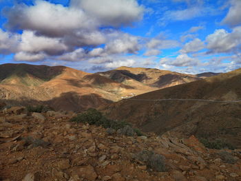 Scenic view of mountains against cloudy sky