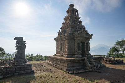 Ruins of temple against building