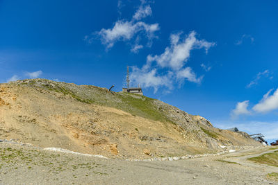 Low angle view of mountain against blue sky