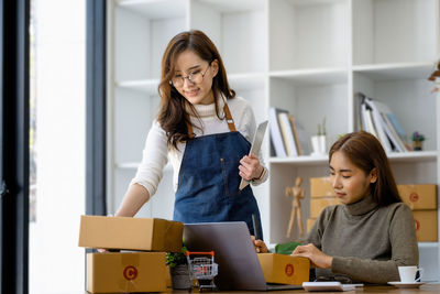 Young woman using laptop at home