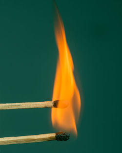 Close-up of fire against blue background