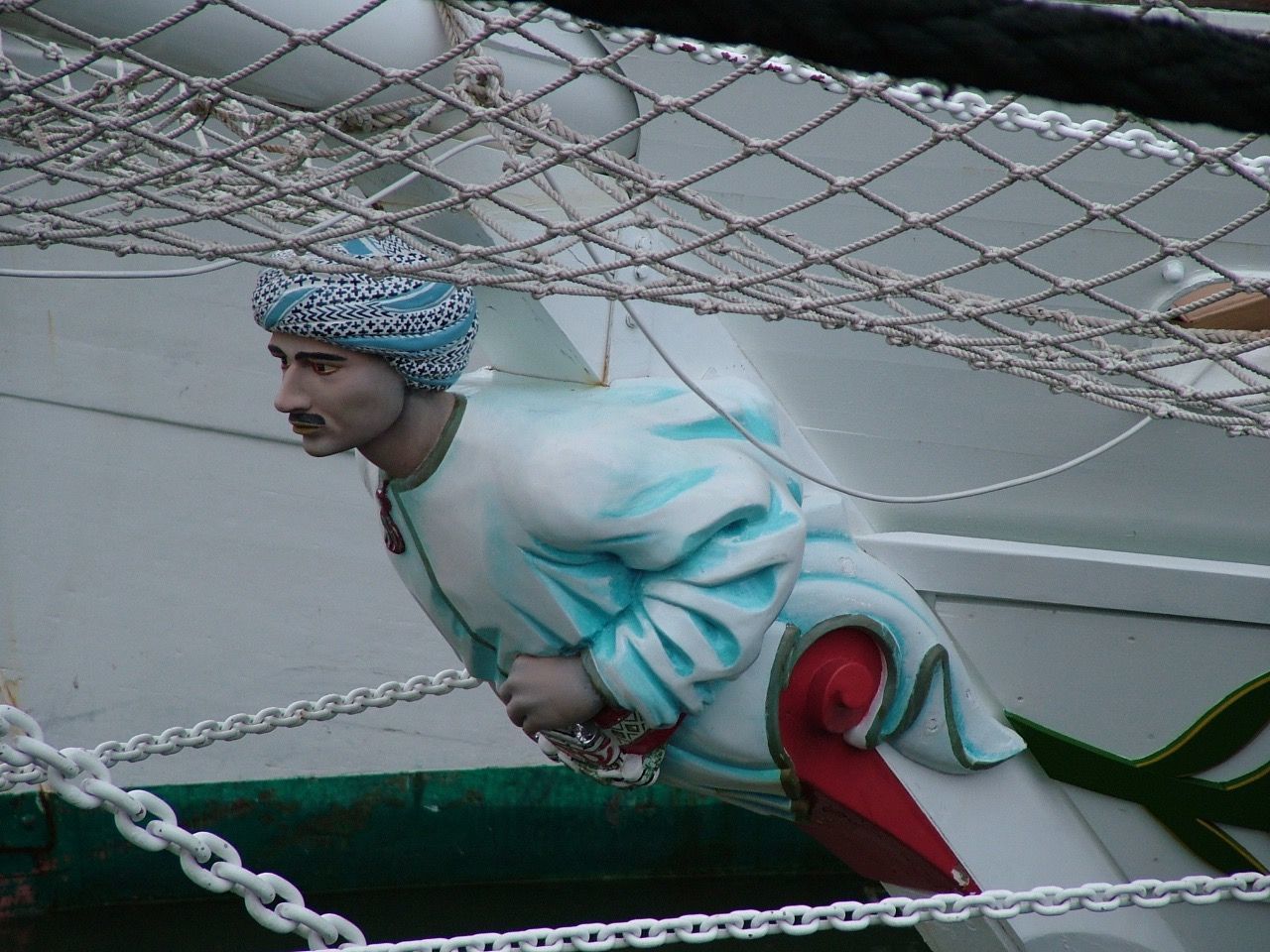 MAN LOOKING AT ROPE FENCE