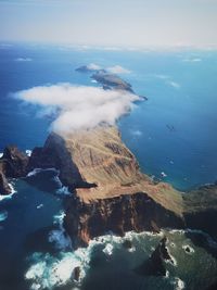 High angle view of sea and rocks against sky