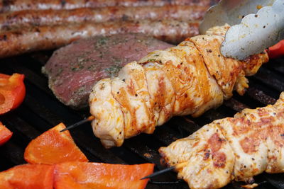 High angle view of meat on barbecue grill