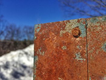 Close-up of rusty metal against sky