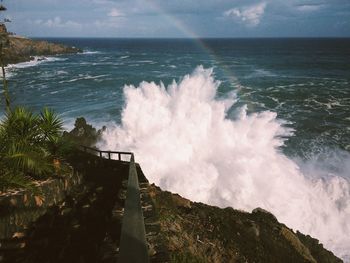 Scenic view of waves crashing on rocks